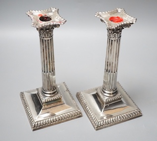 A pair of late Victorian silver Corinthian column candlesticks, Hawksworth, Eyre & Co, Sheffield, 1890, 21.6cm, weighted, sconce a.f.